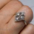 001748 Bague en or et platine, avec chaton comprenant 4 diamants ronds, enfile sur un annulaire.